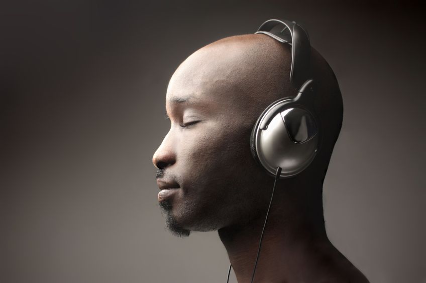 Man wearing headphones with a dark background