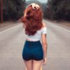 red haired woman with dark denim shorts