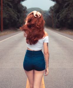 red haired woman with dark denim shorts