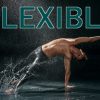 Man splashing in the water as he dances and stretches