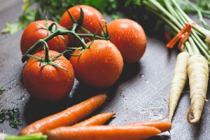 Table with carrots, tomatoes, and radish