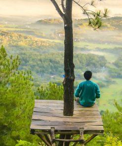 man relaxing in a treehouse feeling very peaceful