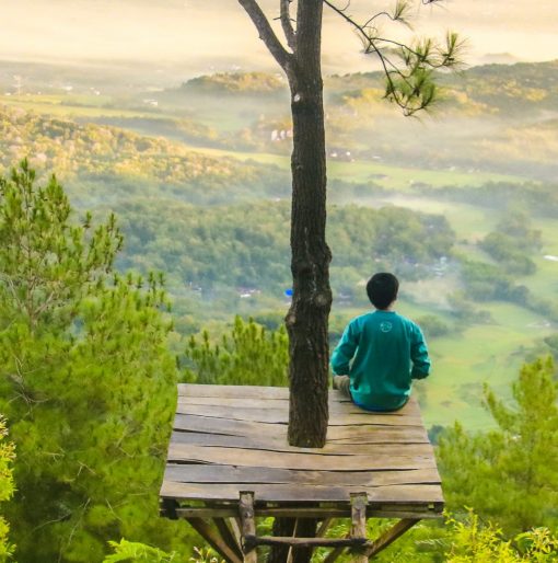 man relaxing in a treehouse feeling very peaceful